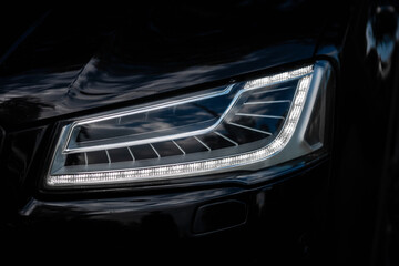 Headlight of Modern Prestigious Black Car Close Up. © Andrii  Kucheruk