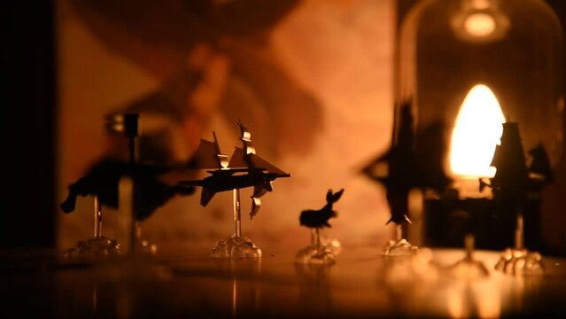 Tabletop miniature ship carousel, slow rotating, relaxing scenery of toys, board game, ships and warm lights, ambience