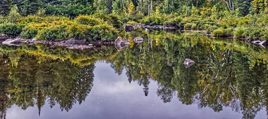 Panorama of still river (Current) with deep reflections, Thunder Bay, ON, Canada