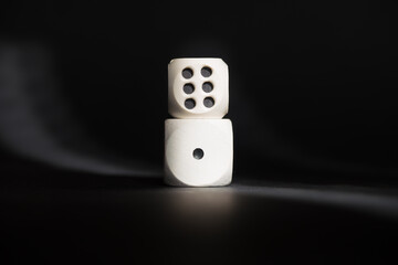 Two dices with number one and number six. Minimum and maximum. Cubes placed one on top of the other. Good luck in casino games. Creative concept of the opposites. 