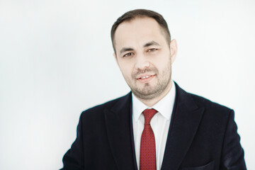 Confident businessman smiling on isolated background.