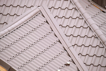 Closeup of house roof top covered with metallic shingles