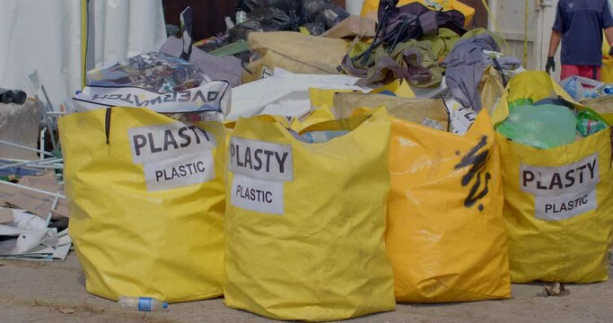 Sorting garbage at a mobile waste sorting point. Plastic in yellow bags before being transported for recycling. CZ, Milovice, 7.8.22 Let it Roll