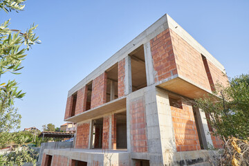 Fototapeta na wymiar Construction of a modern residential building with flat roof