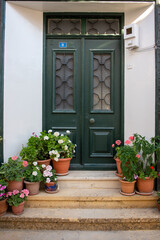 Fototapeta na wymiar Bozcaada's Greek Quarter is very striking with its well-kept houses, beautiful doors, and thousands of flowers. 