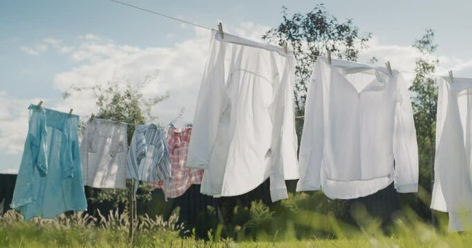 Wet clothes drying in the backyard of the house