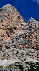 Val Badia, Italy-July 18, 2022: The italian Dolomites behind the small village of Corvara in summer days with beaitiful blue sky in the background. Green nature in the middle of the rocks.