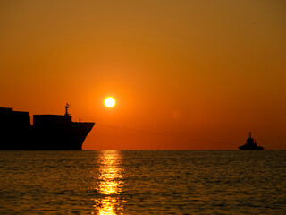 a ship leaving port at sunrise