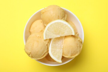 Delicious lemon ice cream on yellow background, top view