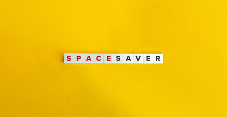 Space Saver Phrase on Block Letter Tiles on Yellow Background. Minimal Aesthetics.