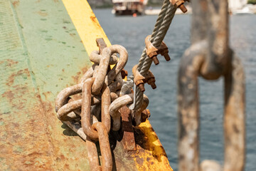 close-up of metal chains, rusty from salt water, attached to a fishing boat, rusty metal chains...