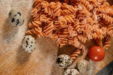 Fototapeta na wymiar Background texture of tricolor fusilli pasta for traditional Italian and Mediterranean cuisine in a close up full frame view