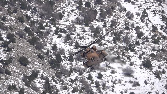 CH-53 Sea Stallion Helicopter flying over snowy mountain
Israeli force in Action, Israel,golan Heights,February,16,2022
