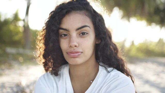 Portrait of young latin hispanic student girl. Generation z healthy lifestyle, natural beauty. charming female model posing outdoors. slow motion 4k.
