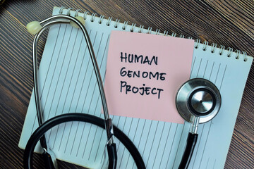 Concept of Human Genome Project write on sticky notes isolated on Wooden Table.