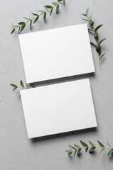 Wedding invitation card mockup with eucalyptus twigs, front and back sides