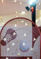 Shuttlecocks were stuck to the badminton steel grill net with a big red drawing of shuttlecock on...