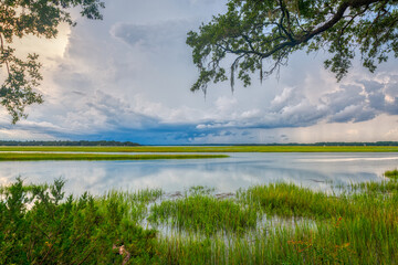 Storm clouds rolling in over coastal river and marsh