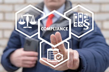 Compliance Standards Regulations Law Balance Business Concept. Businessman using virtual touchscreen presses inscription: compliance.