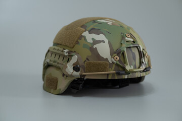 Fototapeta premium Military protective kevlar helmet to protect the head from bullets and shrapnel. The helmet is painted in multicam color