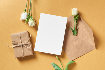 Greeting card mockup with gift box and white flowers