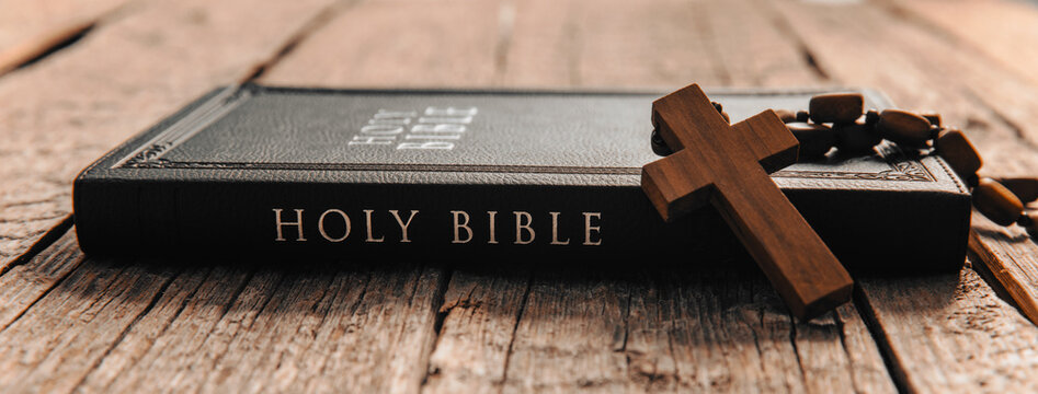 wooden cross on Bible