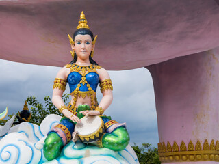 Obraz premium Nikhom Kham Soi, Mukdahan, Thailand - July 31, 2022: Statues of Thai angels in various gestures related to playing a musical instrument