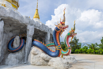 Mukdahan, Thailand - July 31, 2022: Two Nagas at the entrance of the pagoda at Wat Dan Phra In,...