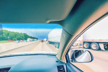 Highway view through the windshield heading into a rainstorm