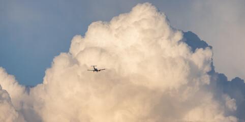 Puff Clouds in the Sky during sunset Airplane Flying. Zoom in. Cloudscape Background. British Columbia, Canada.