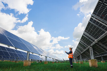 Technicians are checking the operation of the solar power plant equipment so that the power...