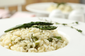 Delicious risotto with asparagus in plate, closeup
