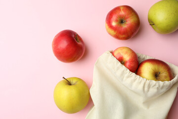 Cotton eco bag and apples on pink background, flat lay