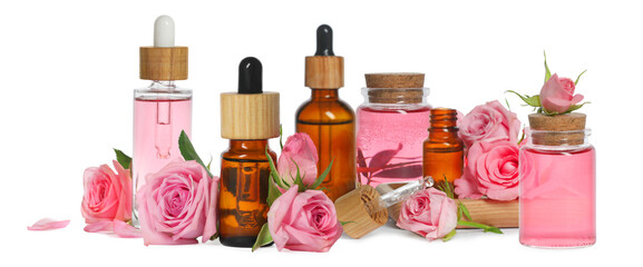 Set with bottles of essential rose oil and flowers on white background. Banner design