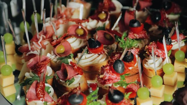 Delicious beautiful canapes are on the table. Shooting a canape close-up