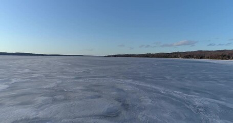  Aerial shot of cold frozen Torch lake landscape in Northern Michigan. 