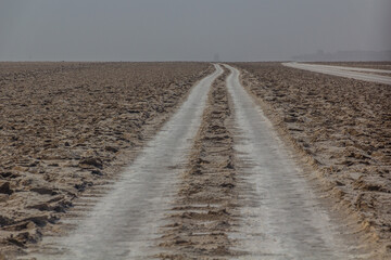 Fototapeta na wymiar Car tracks in salt flats in the Danakil depression, Ethiopia