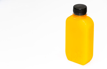Bright orange juice bottle with black cap isolated on white background, minimalistic healthy drink concept, ready for branding and packaging design mockup