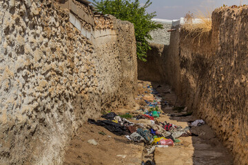Narrow alley with rubbish in the old town in Harar, Ethiopia