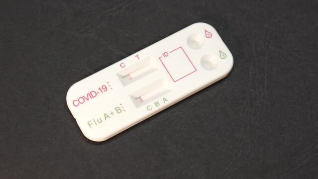 Dual combined covid-19 and flu A+B antigen test for self testing is displayed and rotated