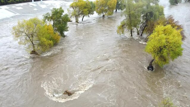 Aerial of a flooded Los Angeles River in Los Angeles California after heavy rain.