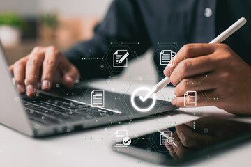 The proper sign for approving an e-document and guaranteeing quality control is made by a businessman using a stylus pen on a digital tablet with a virtual document.
