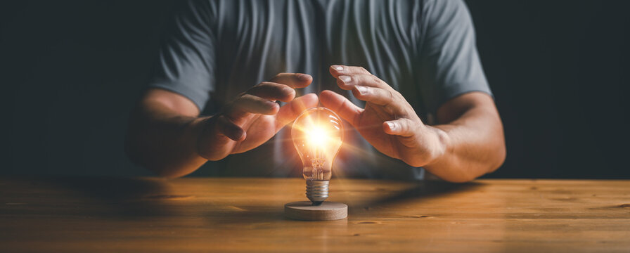 businessman protect light bulb, Creative new idea. Innovation, brainstorming, inspiration and solution concepts...