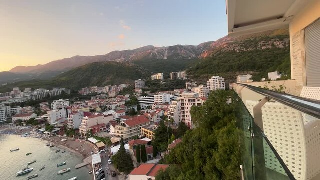mountains over a small fishing town in montenegro called rafailovici during the golden hour sunset, this video was shot on my DJI drone.