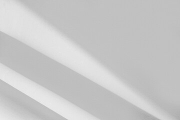 Abstract light reflection and grey shadow from window on white wall background. Gray shadow and sunshine diagonal geometric overlay effect