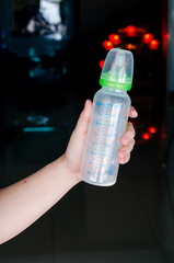 milk bottle in women hand and blur background