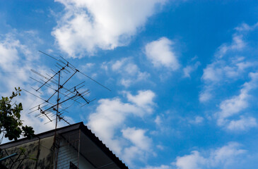 Old antenna on the old building over the blue sky