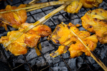 Thai Street Food, grilled chicken on charcoal.
