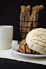 closed shot of sweet bread on a white plate on a black background