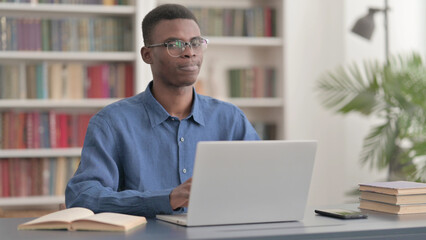 Rejecting Young African Man in Denial while using Laptop